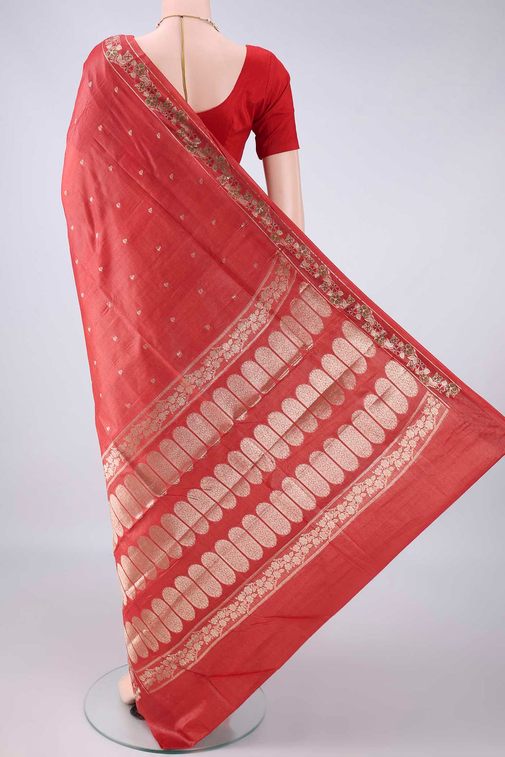Flat view of Brick Orange Banarasi Tussar Saree with Zari Butta on the body and Zari And Thread Border. 