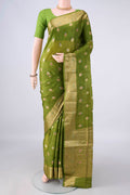 Light Green Banarasi Tussar Saree with Zari And Thread Butta on the body and Zari Border.  displayed on a mannequin