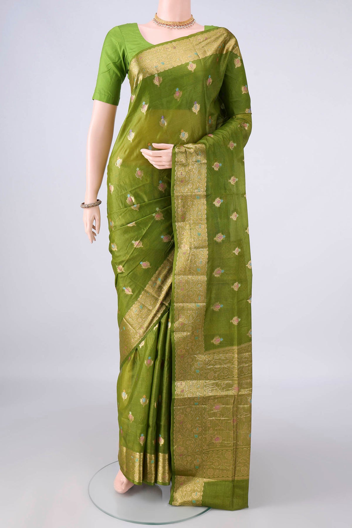 Light Green Banarasi Tussar Saree with Zari And Thread Butta on the body and Zari Border.  displayed on a mannequin