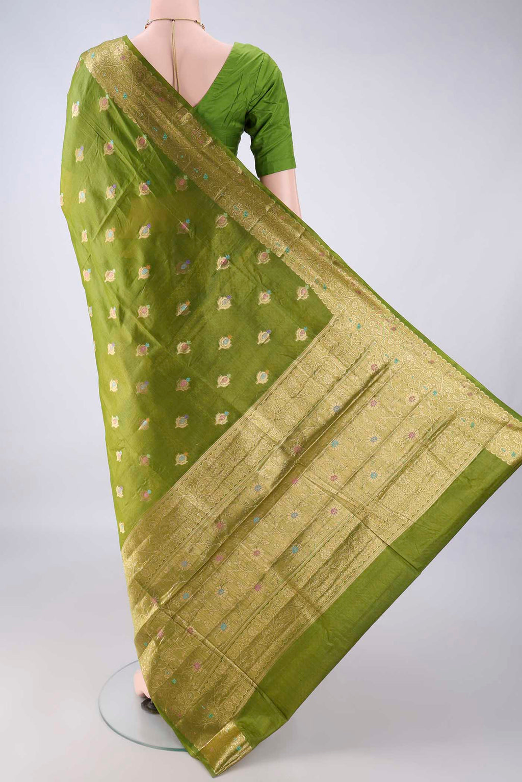 Flat view of Light Green Banarasi Tussar Saree with Zari And Thread Butta on the body and Zari Border. 