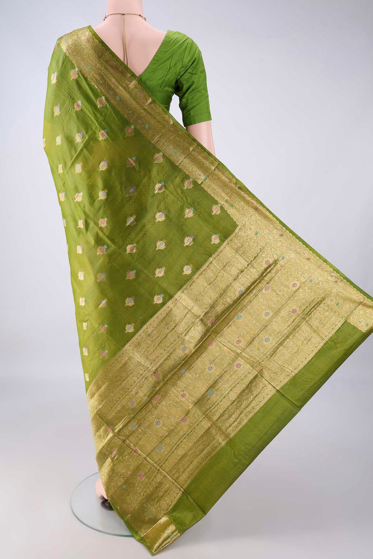 Flat view of Light Green Banarasi Tussar Saree with Zari And Thread Butta on the body and Zari Border. 