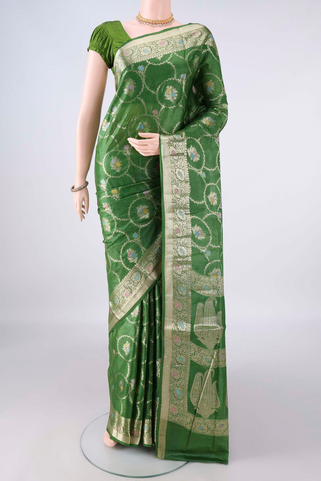 Green Banarasi Tussar Saree with Zari Brocade on the body and Zari Border.  displayed on a mannequin