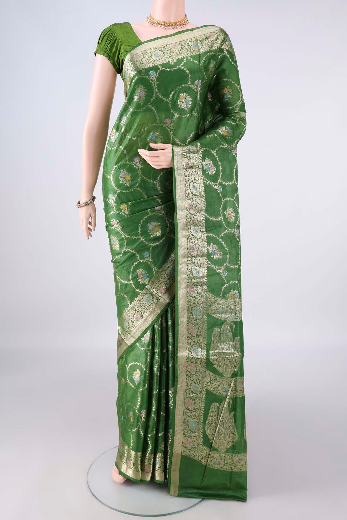 Green Banarasi Tussar Saree with Zari Brocade on the body and Zari Border.  displayed on a mannequin