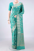Sea Green Banarasi Tussar Saree with Zari Brocade on the body and Zari And Thread Border.  displayed on a mannequin