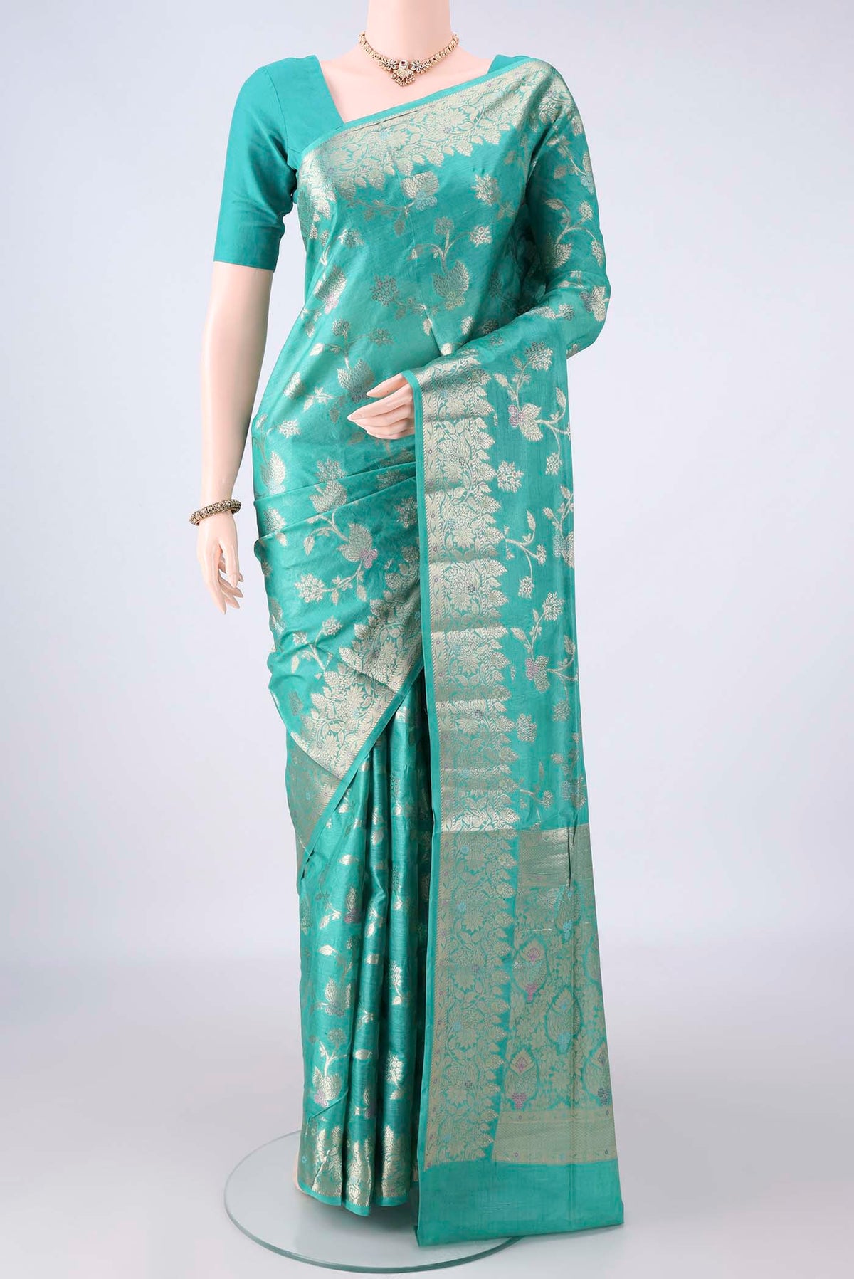 Sea Green Banarasi Tussar Saree with Zari Brocade on the body and Zari And Thread Border.  displayed on a mannequin