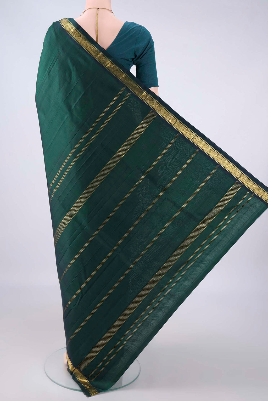 Flat view of Pure Silk Bottle Green Kanjivaram Saree with Plain Body and Zari Border. 