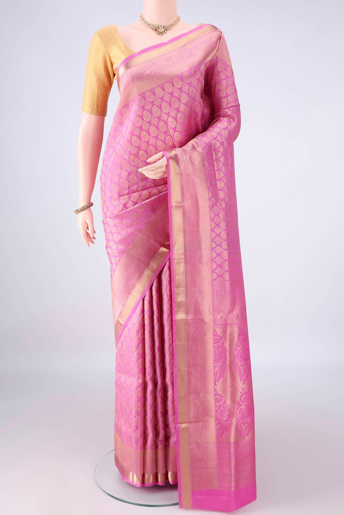 Pure Silk Pink Soft Saree with Zari Brocade on the body and Zari Border.  displayed on a mannequin