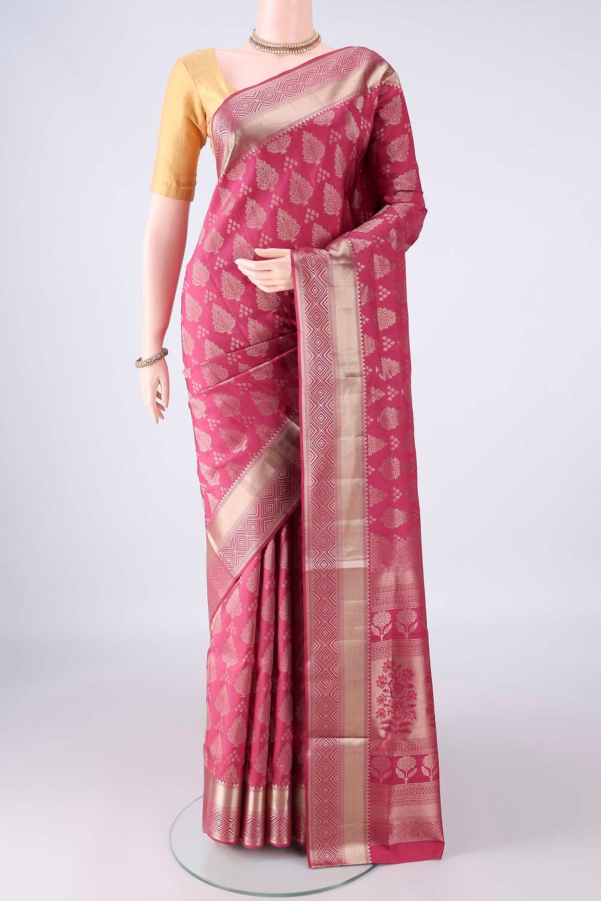 Pure Silk Imperial Pink Soft Saree with Zari Butta on the body and Zari Border.  displayed on a mannequin