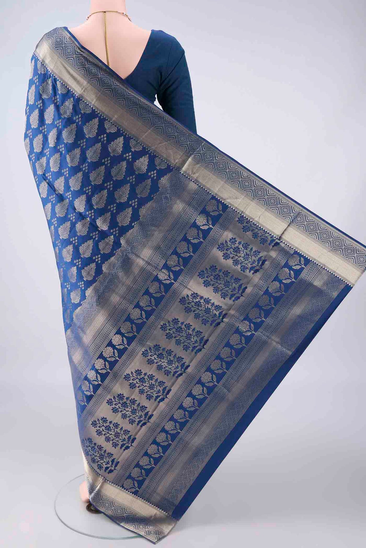 Flat view of Pure Silk Blue Soft Saree with Zari Butta on the body and Zari Border. 