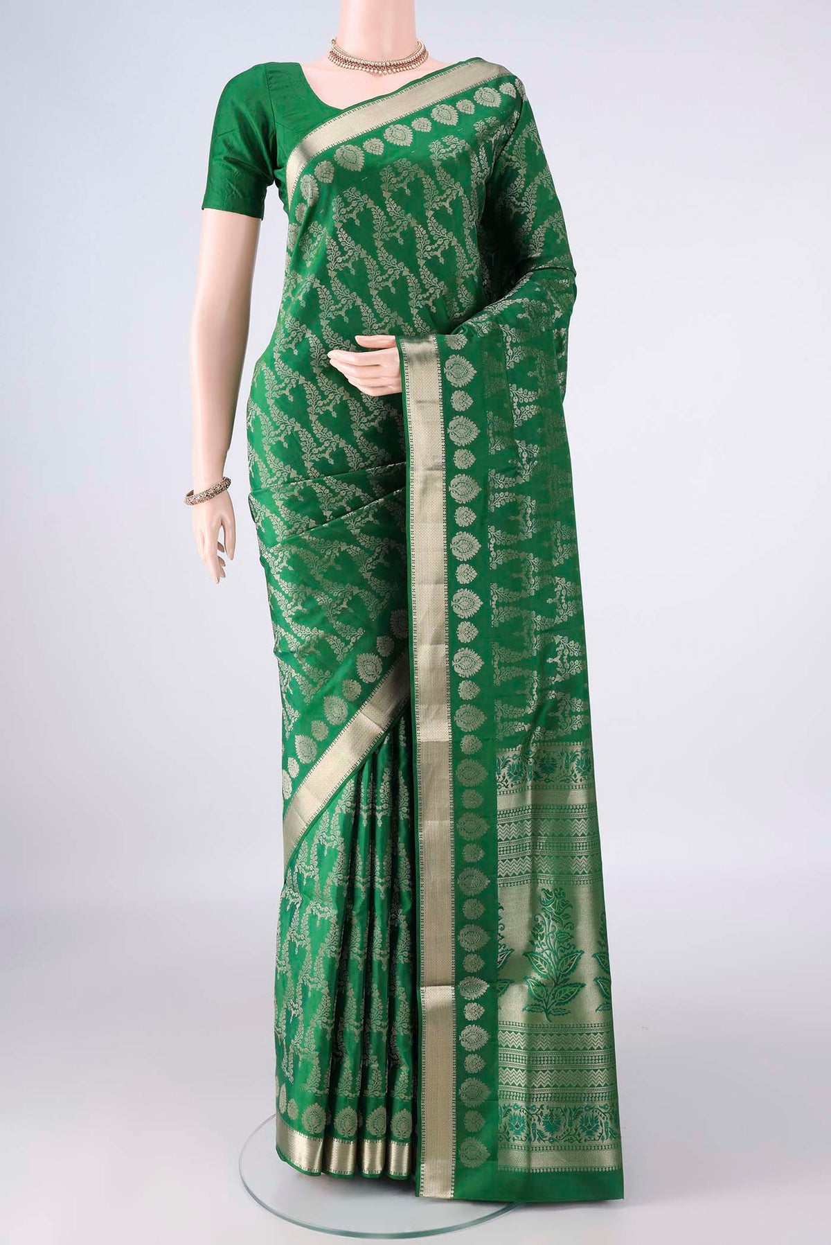 Pure Silk Green Soft Saree with Zari Brocade on the body and Zari Border.  displayed on a mannequin