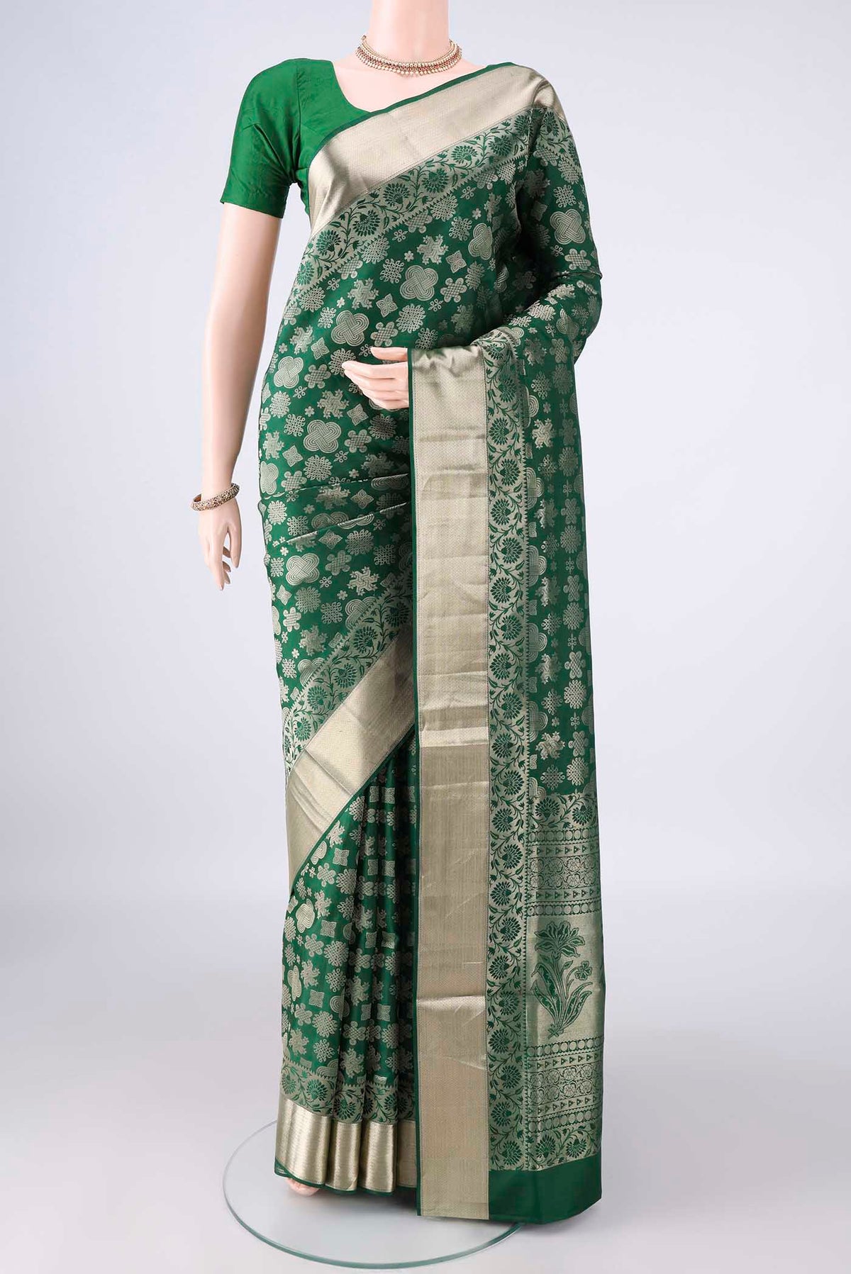 Pure Silk Bottle Green Soft Saree with Zari Brocade on the body and Zari Border.  displayed on a mannequin