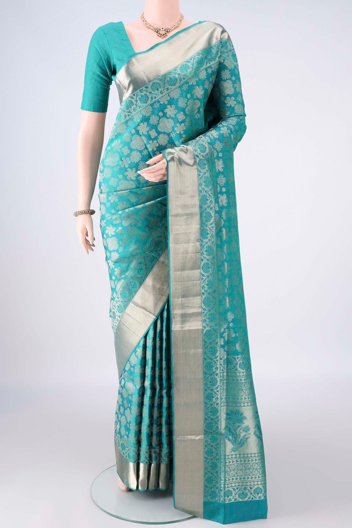 Pure Silk Sea Green Soft Saree with Zari Brocade on the body and Zari Border.  displayed on a mannequin