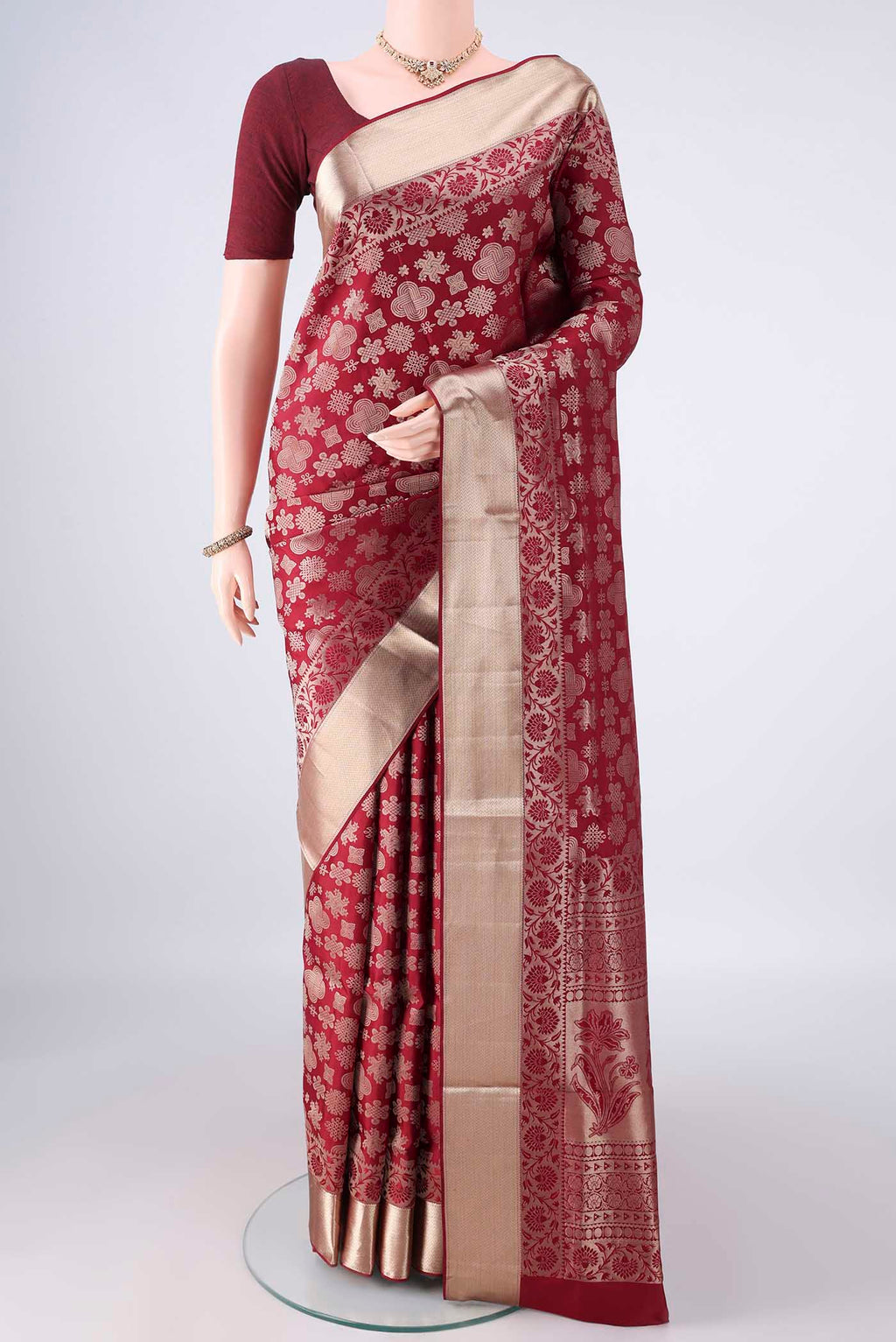 Pure Silk Maroon Soft Saree with Zari Butta on the body and Zari Border.  displayed on a mannequin