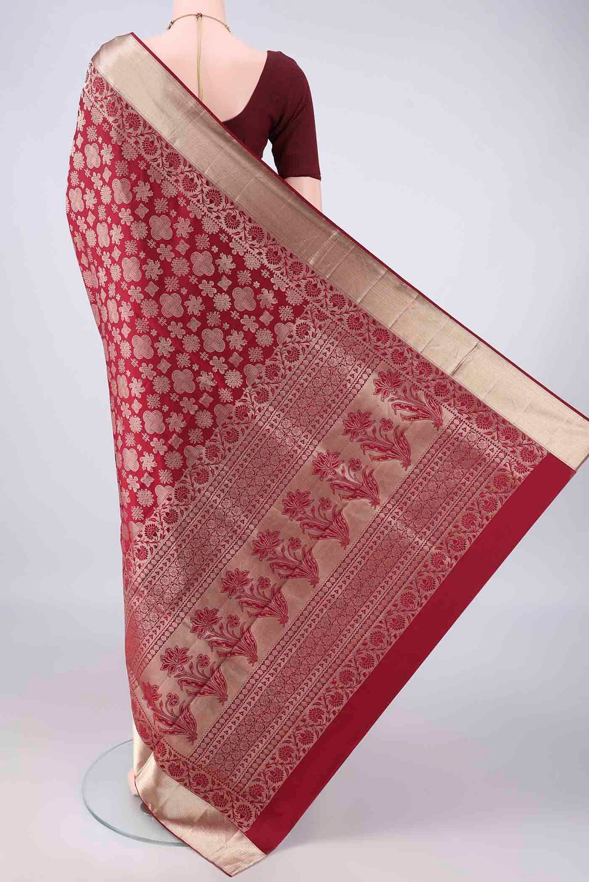 Flat view of Pure Silk Maroon Soft Saree with Zari Butta on the body and Zari Border. 