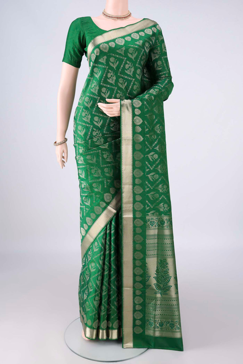 Pure Silk Green Soft Saree with Zari Brocade on the body and Zari Border.  displayed on a mannequin