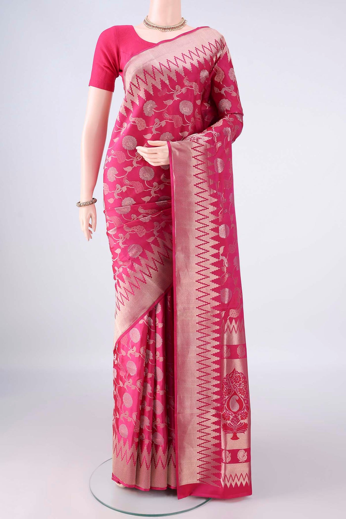 Pure Silk Rani Pink Soft Saree with Zari Brocade on the body and Zari Border.  displayed on a mannequin