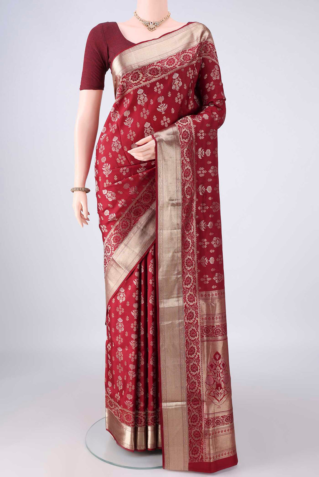 Pure Silk Maroon Soft Saree with Zari Butta on the body and Zari Border.  displayed on a mannequin
