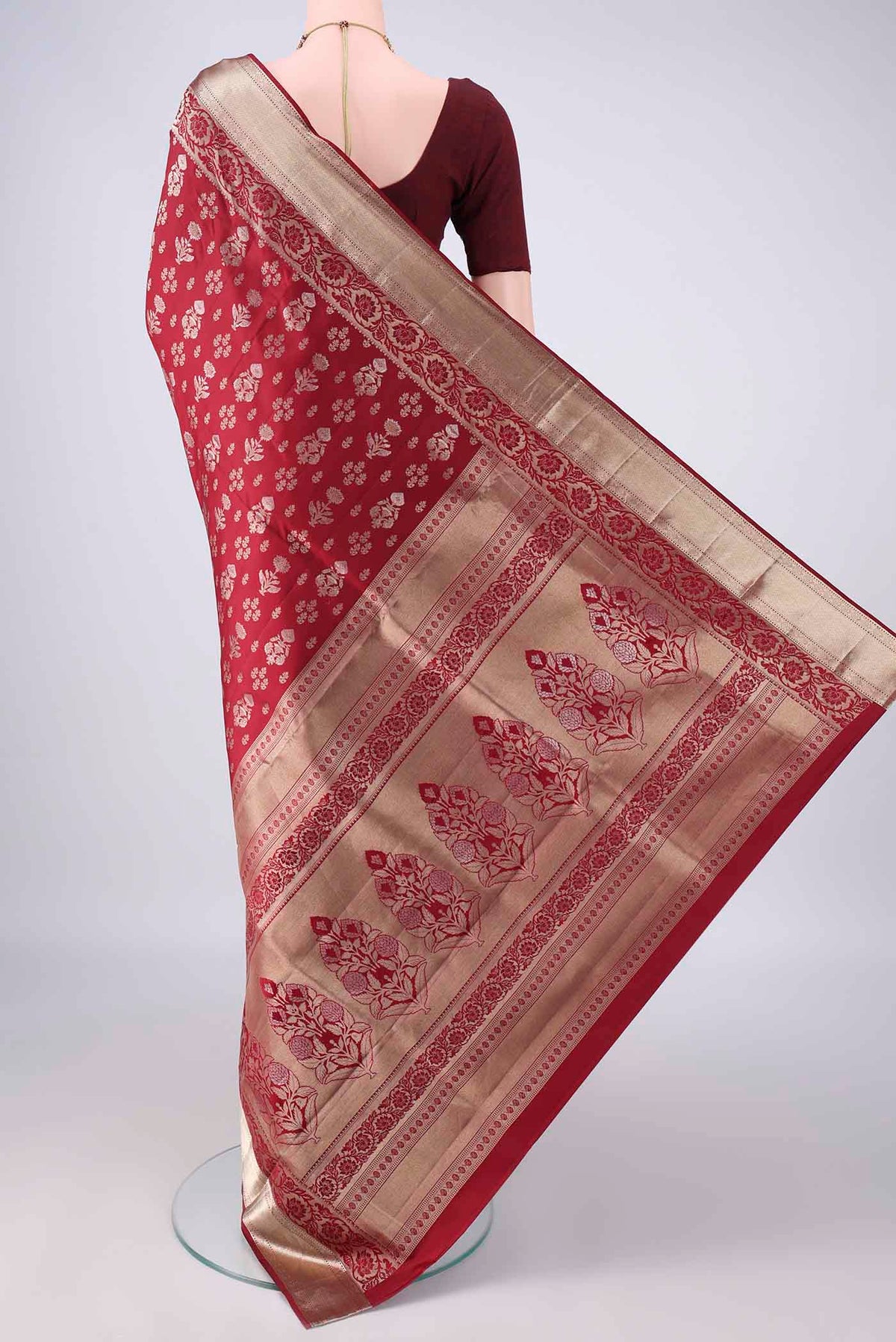 Flat view of Pure Silk Maroon Soft Saree with Zari Butta on the body and Zari Border. 