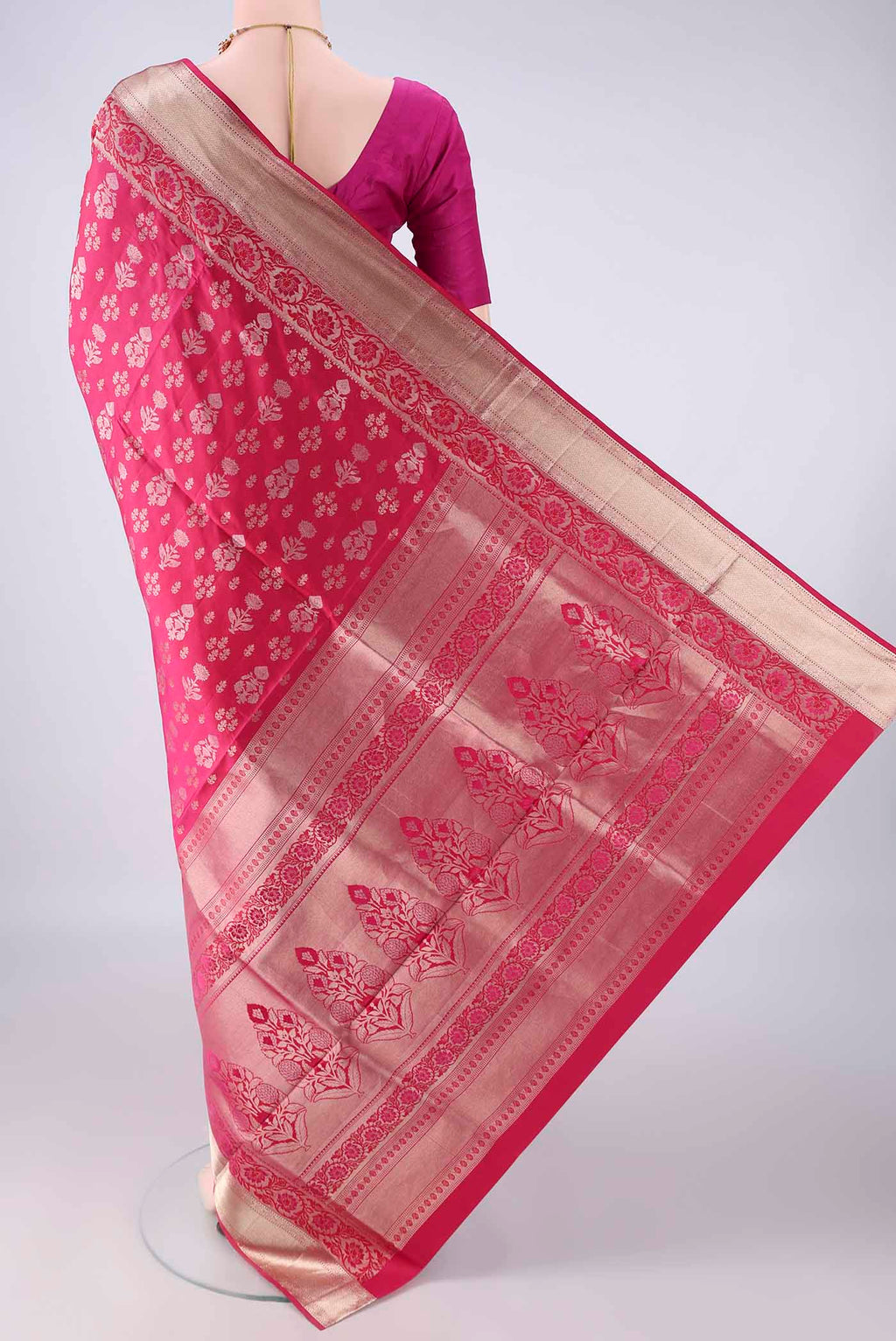 Flat view of Pure Silk Rani Pink Soft Saree with Zari Butta on the body and Zari Border. 