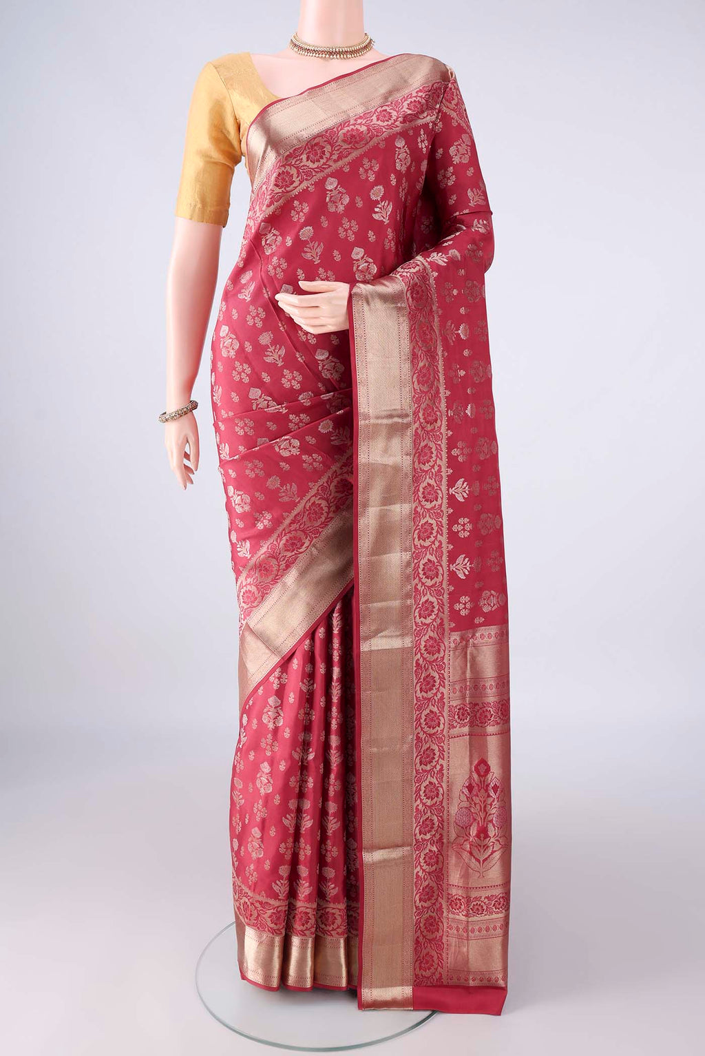 Pure Silk Coral Soft Saree with Zari Butta on the body and Zari Border.  displayed on a mannequin