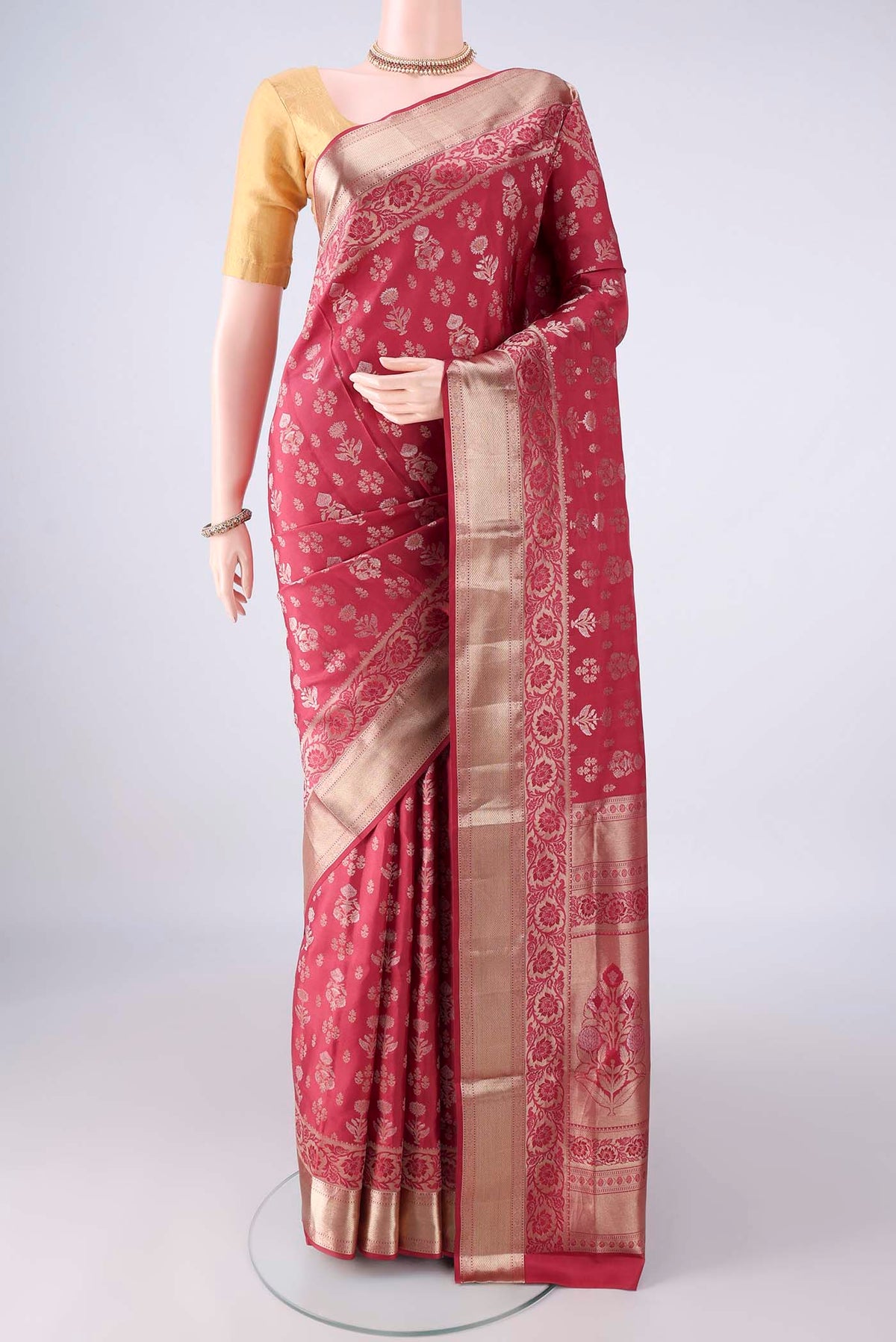 Pure Silk Coral Soft Saree with Zari Butta on the body and Zari Border.  displayed on a mannequin