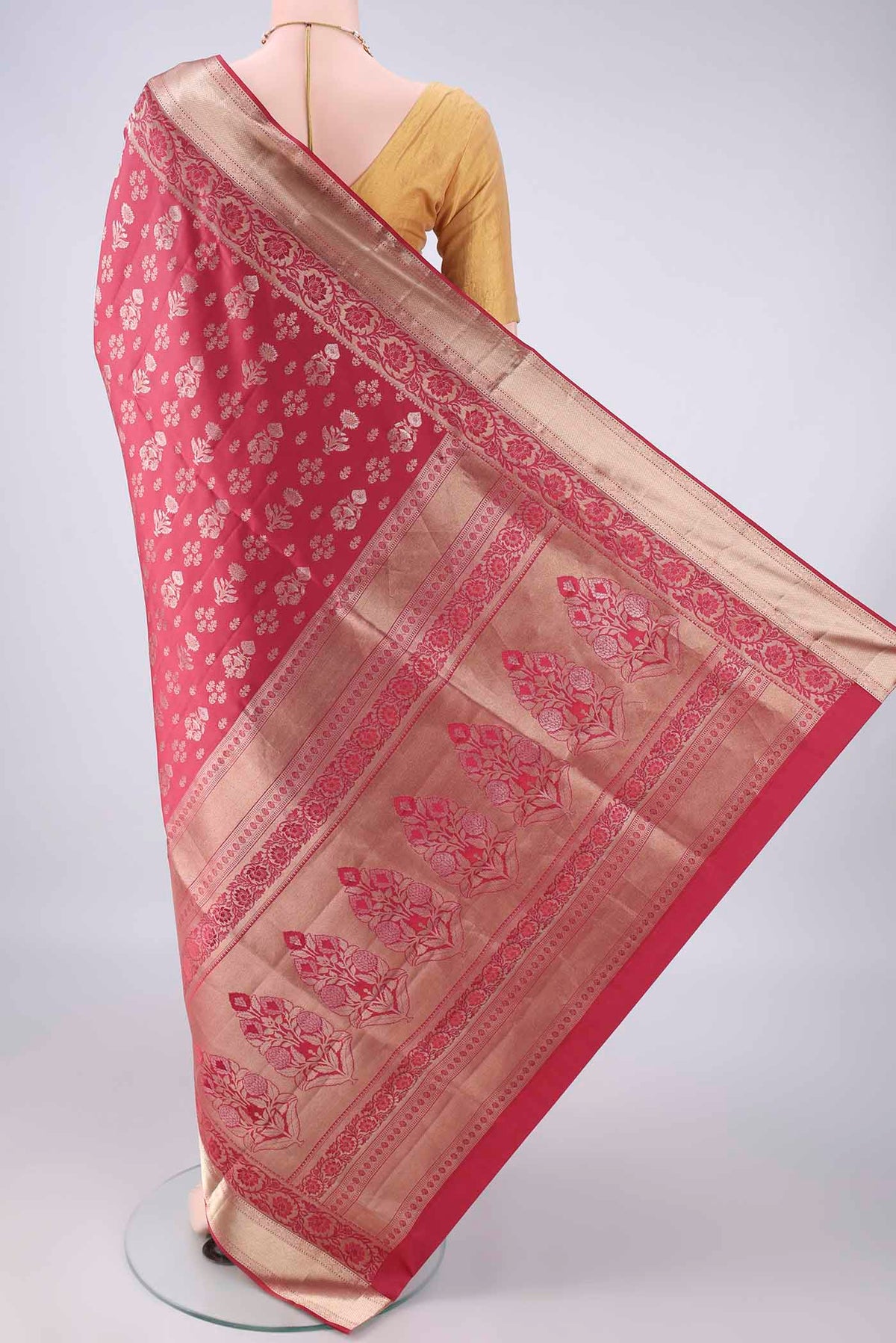 Flat view of Pure Silk Coral Soft Saree with Zari Butta on the body and Zari Border. 