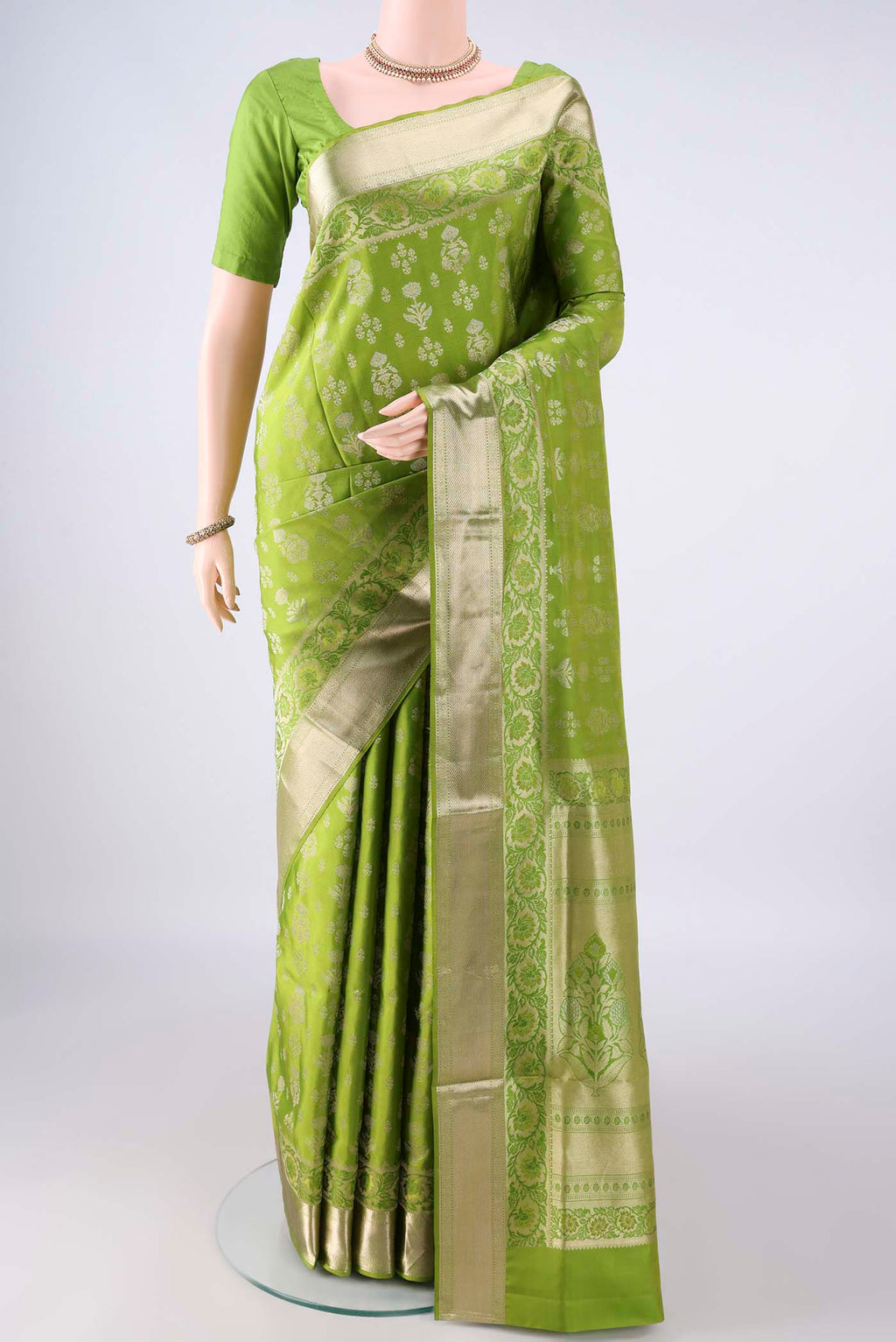 Pure Silk Light Green Soft Saree with Zari Butta on the body and Zari Border.  displayed on a mannequin
