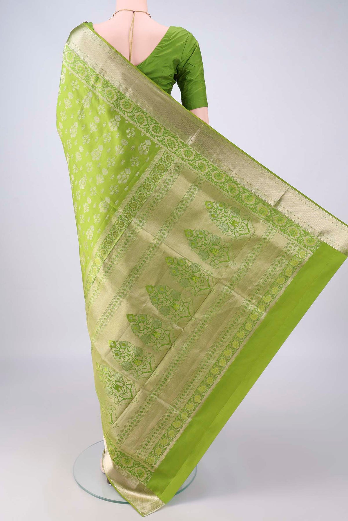 Flat view of Pure Silk Light Green Soft Saree with Zari Butta on the body and Zari Border. 