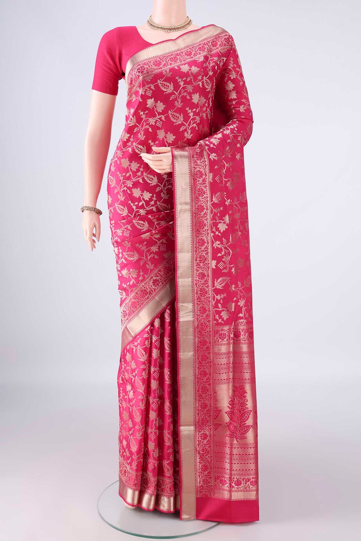 Pure Silk Rani Pink Soft Saree with Zari Brocade on the body and Zari Border.  displayed on a mannequin