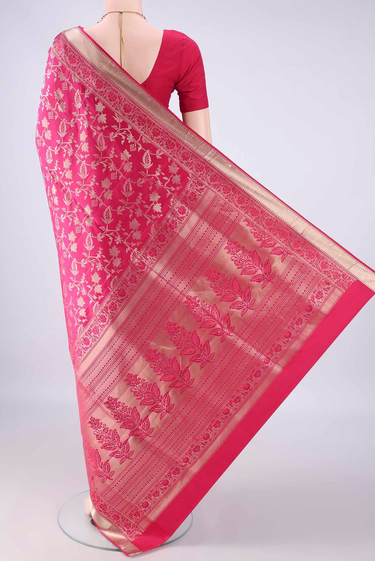 Flat view of Pure Silk Rani Pink Soft Saree with Zari Brocade on the body and Zari Border. 