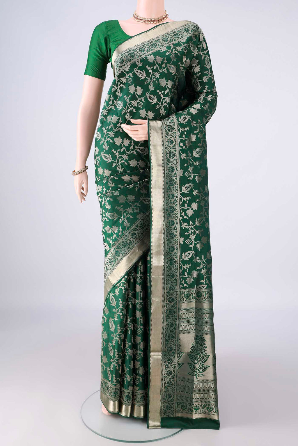 Pure Silk Bottle Green Soft Saree with Zari Brocade on the body and Zari Border.  displayed on a mannequin