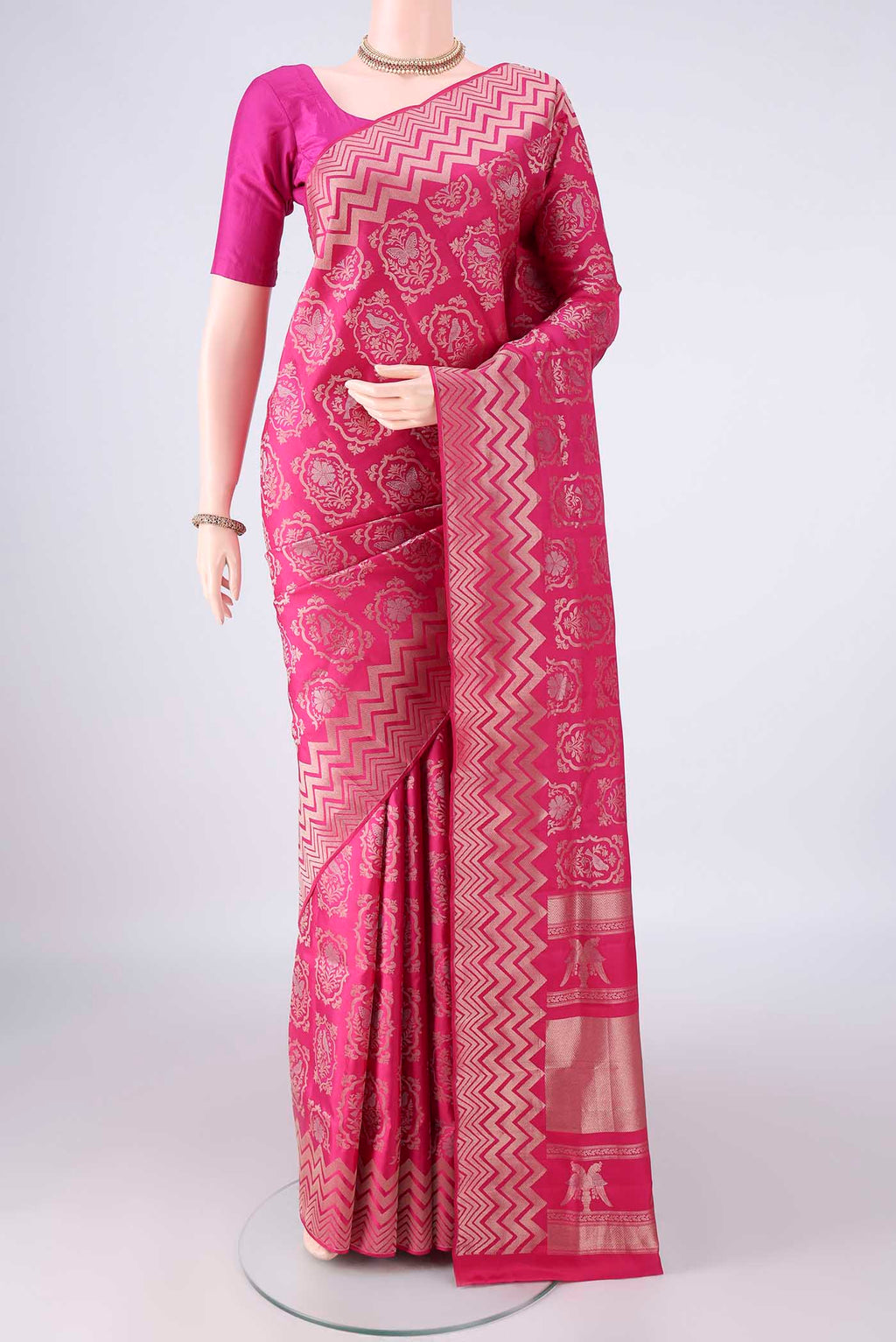 Pure Silk Rani Pink Soft Saree with Zari Brocade on the body and Zari Border.  displayed on a mannequin