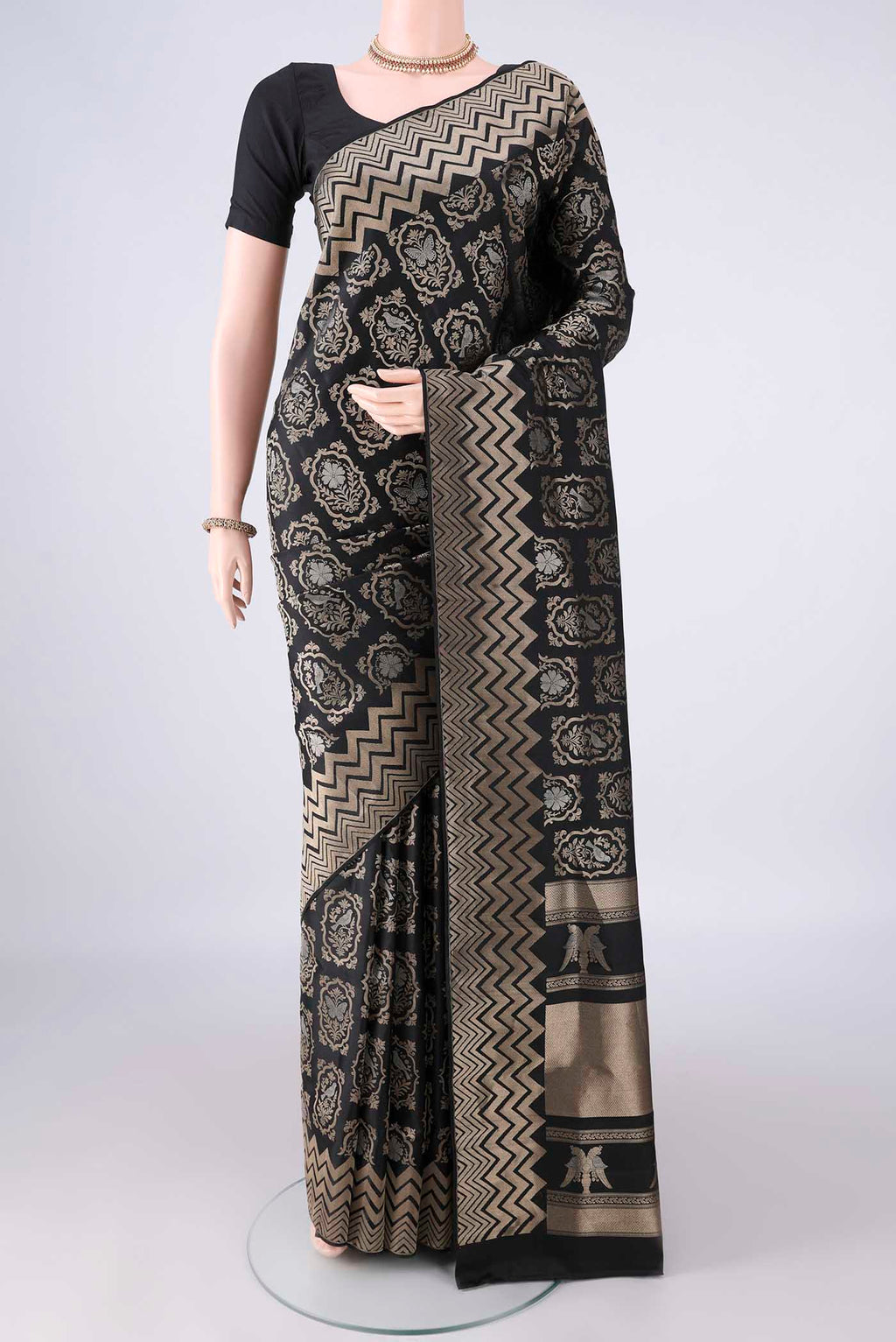 Pure Silk Black Soft Saree with Zari Brocade on the body and Zari Border.  displayed on a mannequin