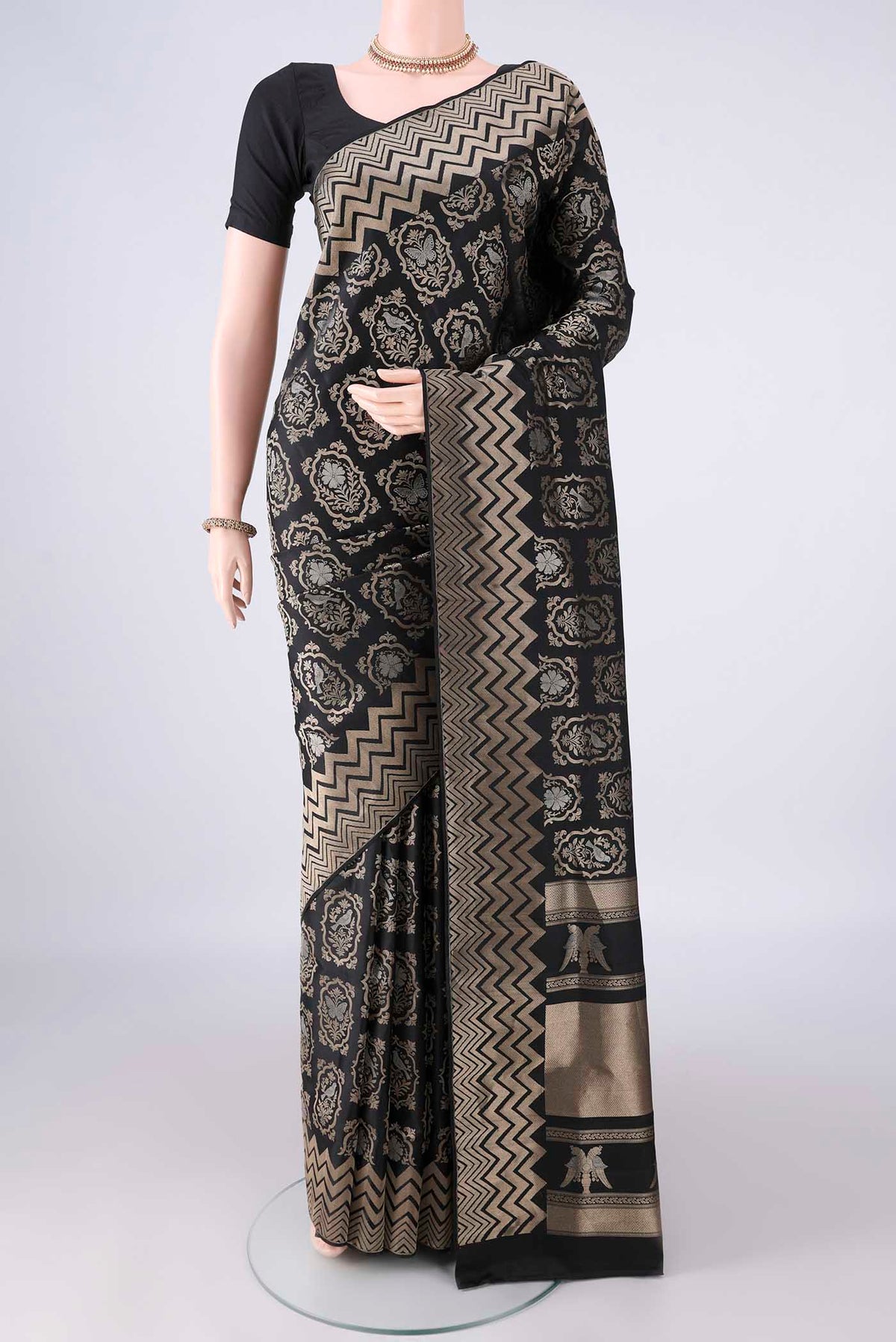 Pure Silk Black Soft Saree with Zari Brocade on the body and Zari Border.  displayed on a mannequin