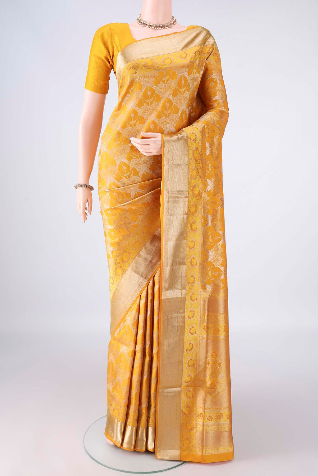 Pure Silk Yellow Soft Saree with Zari Brocade on the body and Zari Border.  displayed on a mannequin