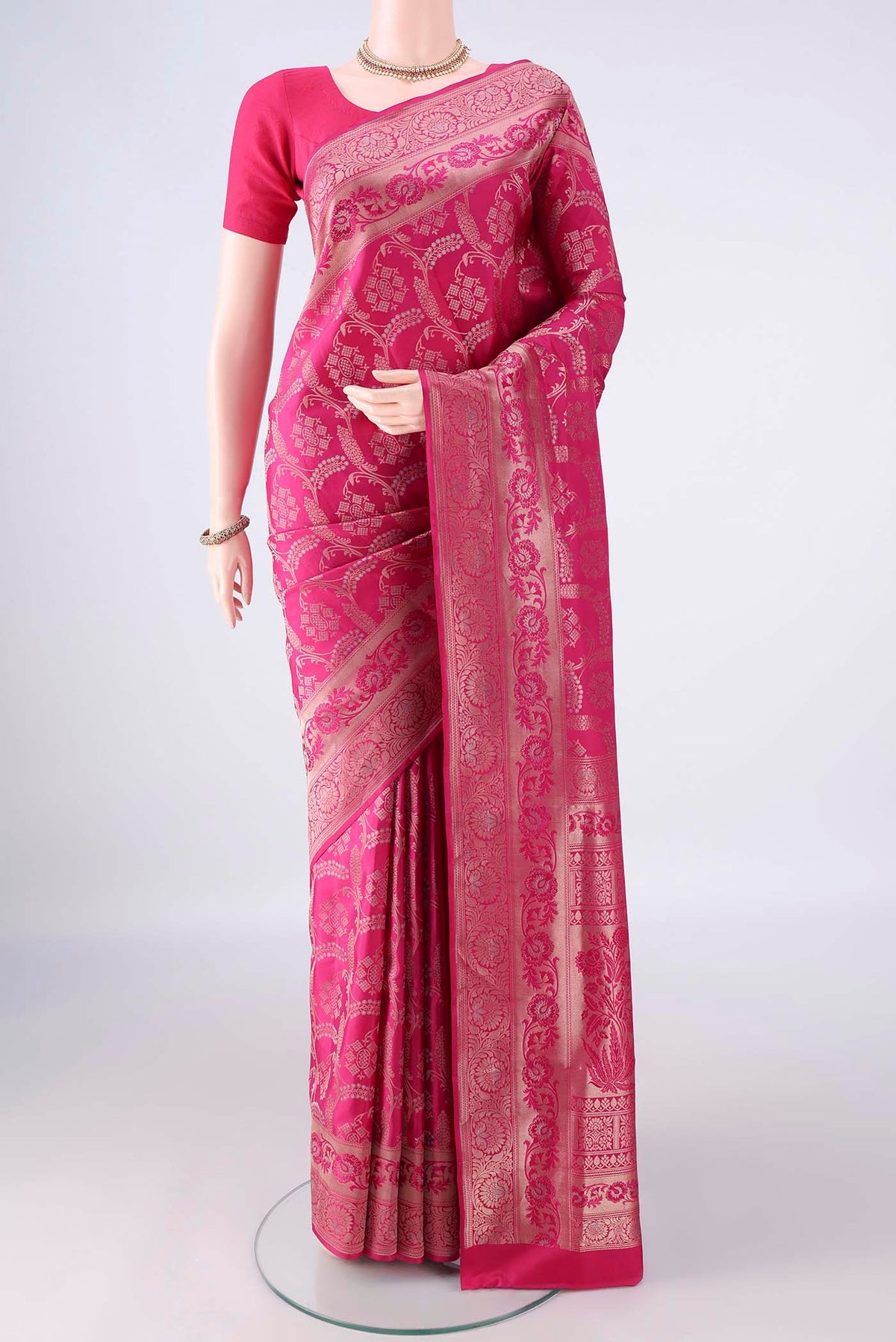 Pure Silk Rani Pink Soft Saree with Zari Brocade on the body and Zari Border.  displayed on a mannequin