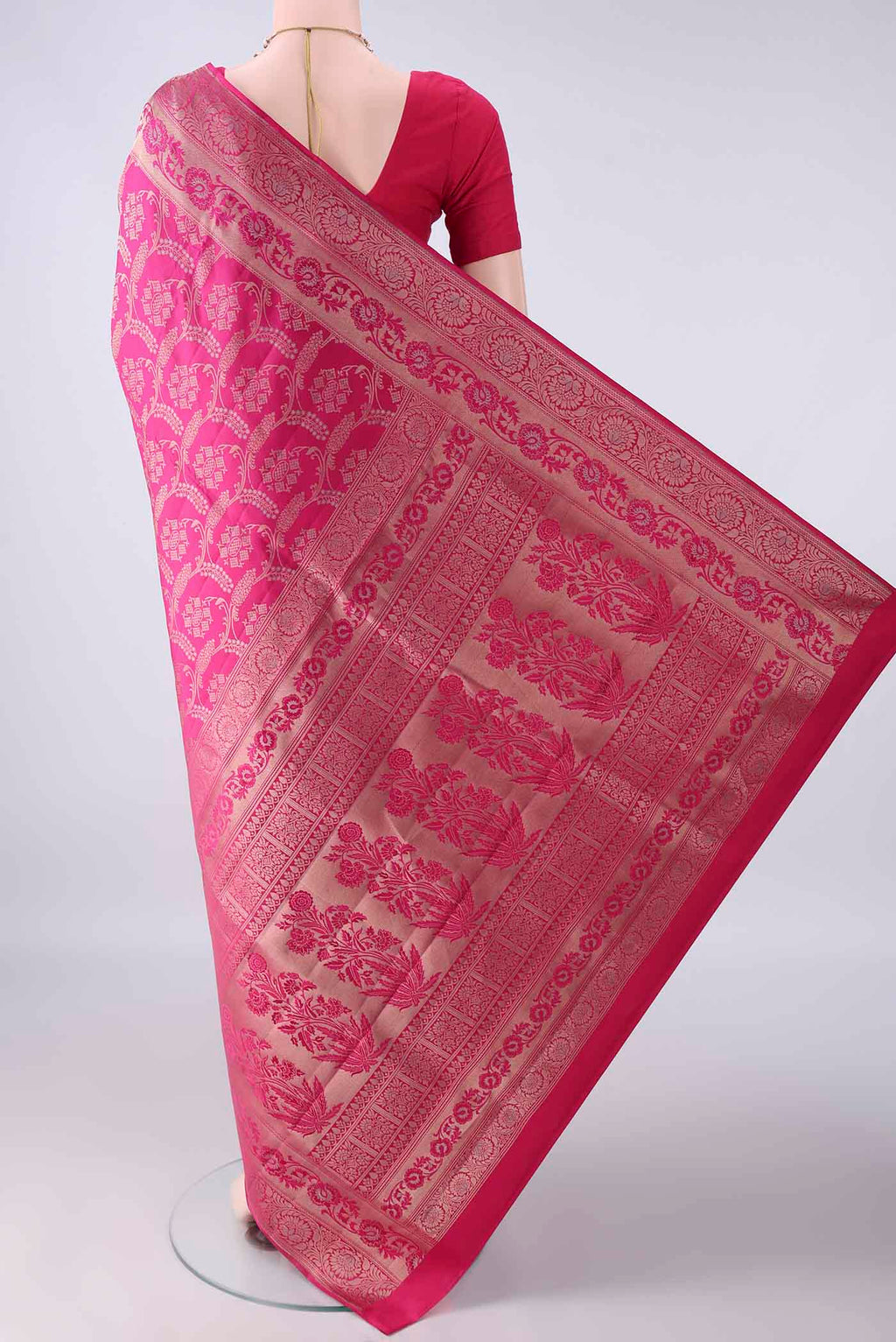 Flat view of Pure Silk Rani Pink Soft Saree with Zari Brocade on the body and Zari Border. 