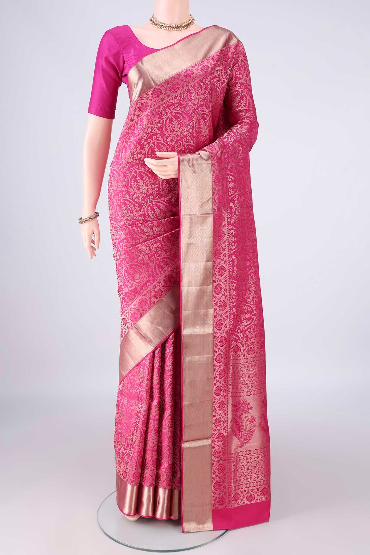 Pure Silk Rani Pink Soft Saree with Zari Brocade on the body and Zari Border.  displayed on a mannequin