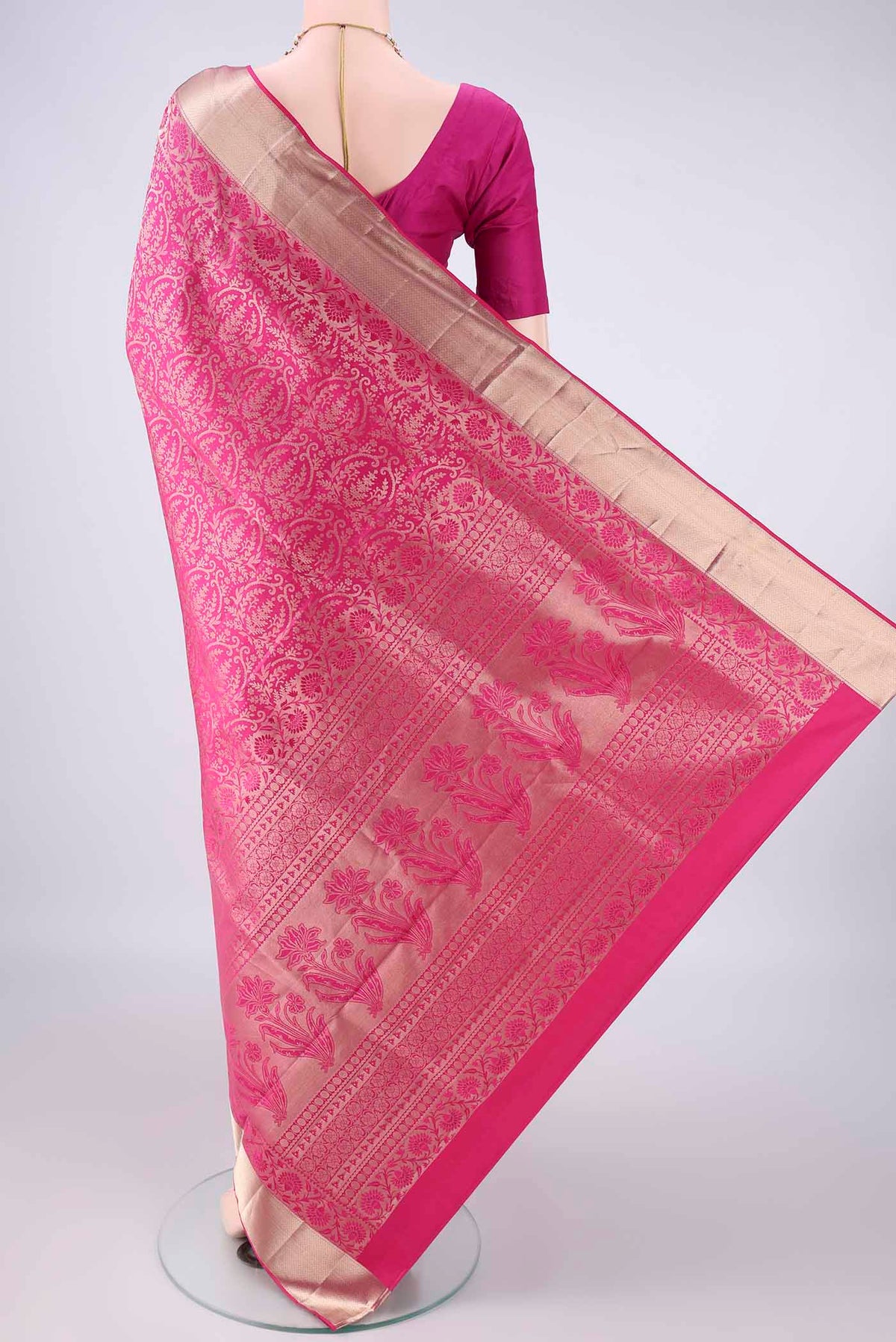Flat view of Pure Silk Rani Pink Soft Saree with Zari Brocade on the body and Zari Border. 