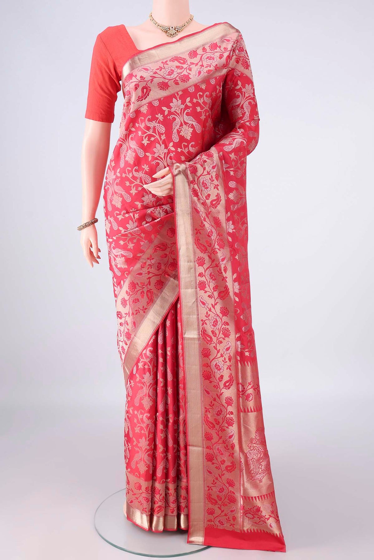 Pure Silk Coral Soft Saree with Zari Brocade on the body and Zari Border.  displayed on a mannequin