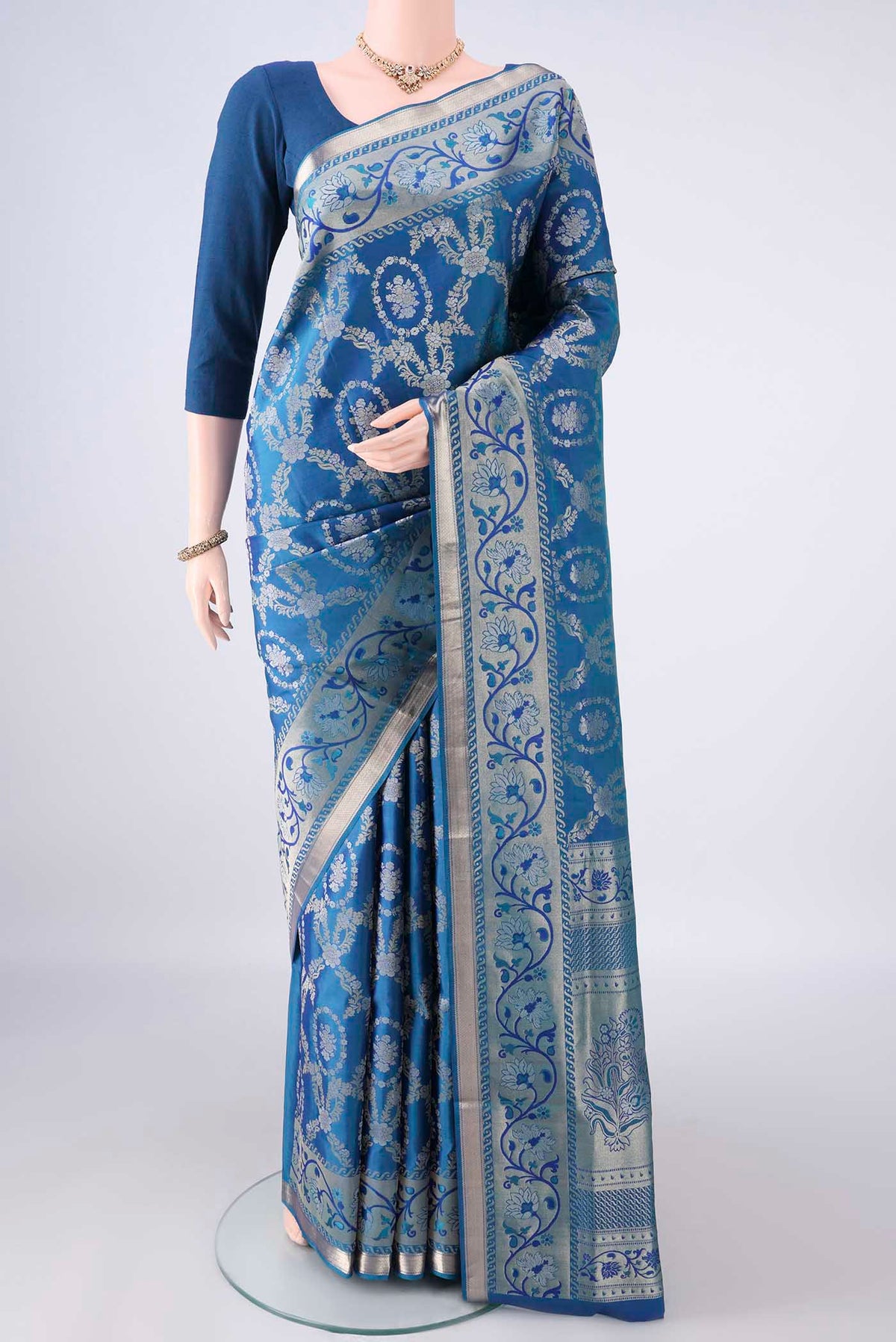 Pure Silk Peacock Blue Soft Saree with Zari Brocade on the body and Zari Border.  displayed on a mannequin