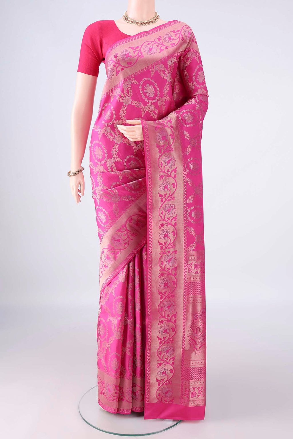 Pure Silk Rani Pink Soft Saree with Zari Brocade on the body and Zari Border.  displayed on a mannequin