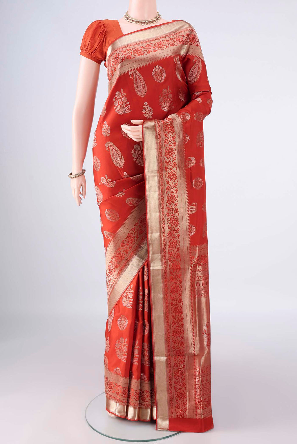 Pure Silk Brick Orange Soft Saree with Zari Brocade on the body and Zari Border.  displayed on a mannequin