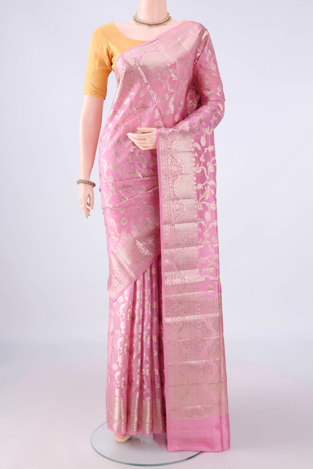Pure Silk Pink Banarasi Raw Saree with Zari Butta on the body and Zari Border.  displayed on a mannequin