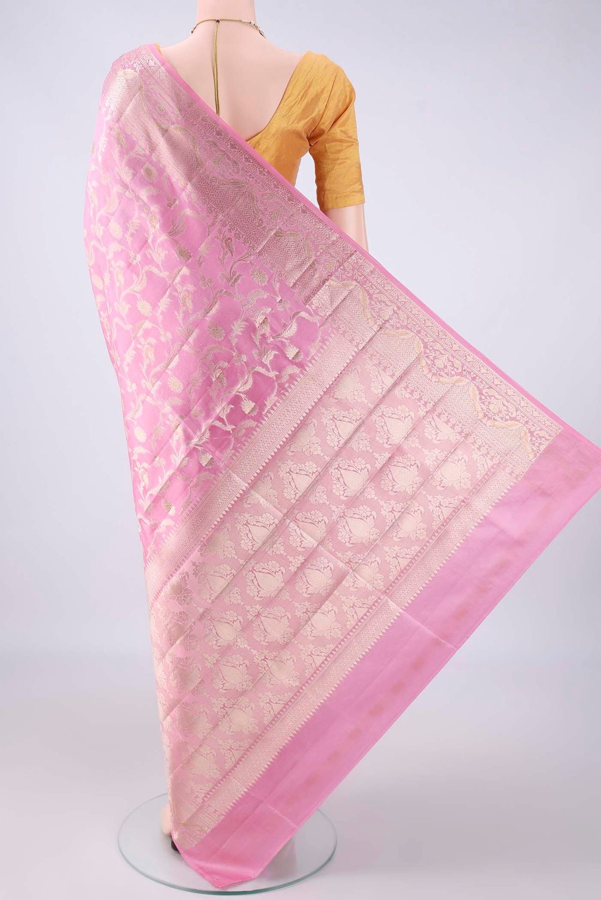 Flat view of Pure Silk Pink Banarasi Raw Saree with Zari Butta on the body and Zari Border. 