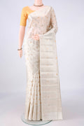 Pure Silk Off White Banarasi Raw Saree with Zari Butta on the body and Zari Border.  displayed on a mannequin