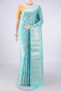 Pure Silk Sky Blue Banarasi Raw Saree with Zari Butta on the body and Zari Border.  displayed on a mannequin