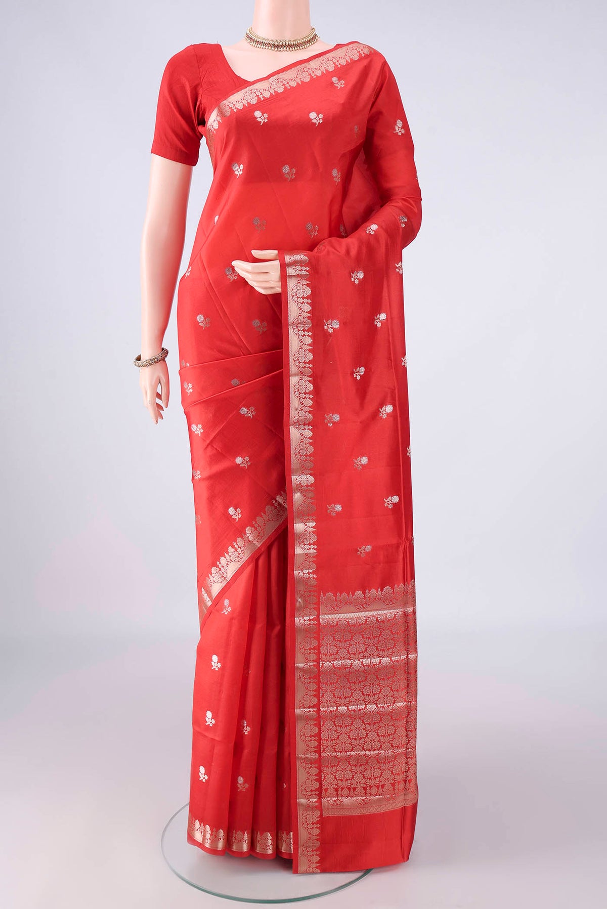 Pure Silk Red Banarasi Raw Saree with Zari Butta on the body and Zari Border.  displayed on a mannequin