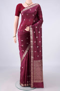 Pure Silk Burgundy Banarasi Raw Saree with Zari Butta on the body and Zari Border.  displayed on a mannequin