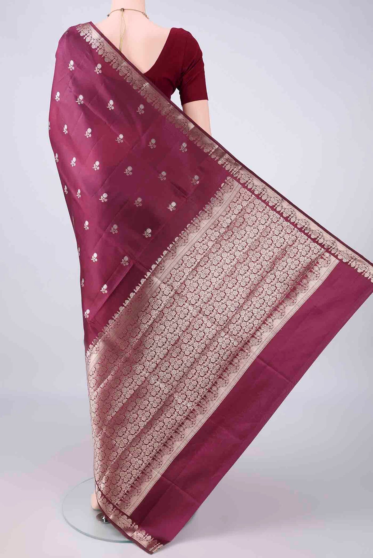 Flat view of Pure Silk Burgundy Banarasi Raw Saree with Zari Butta on the body and Zari Border. 